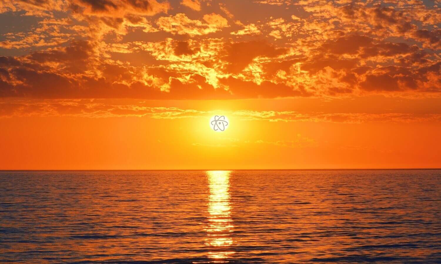 atom logo with setting sun